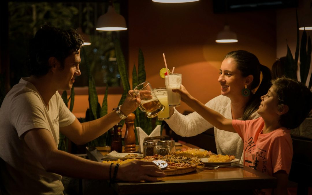 three people having a toast on table